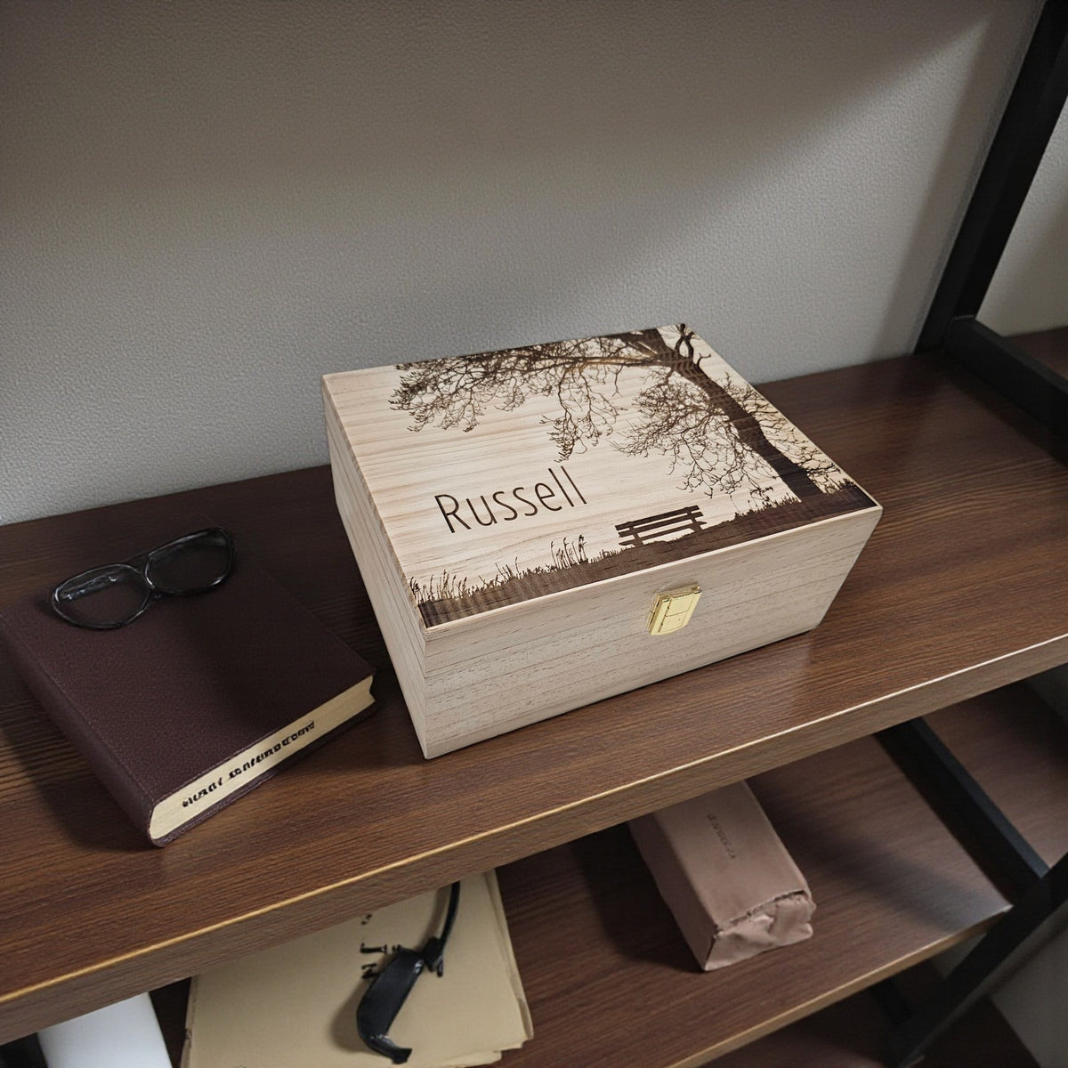 Newfashioned Relics personalized wooden keepsake box with tree engraving and the name Russell on a wooden shelf.