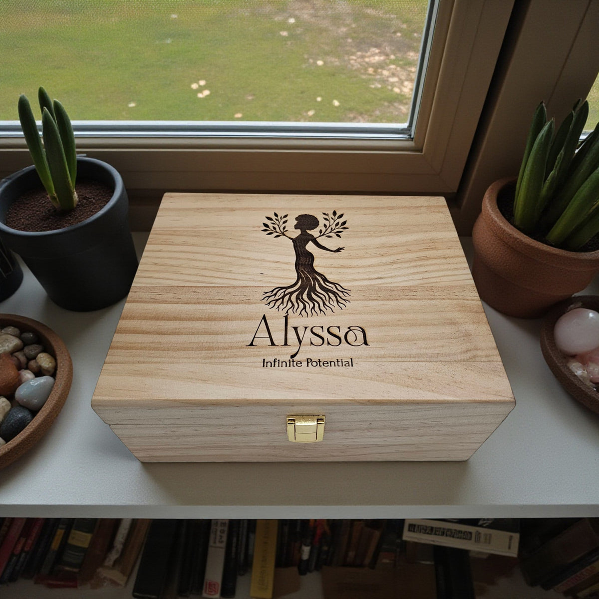 Newfashioned Relics personalized wooden keepsake box with engraved tree woman design and name Alyssa on a windowsill.